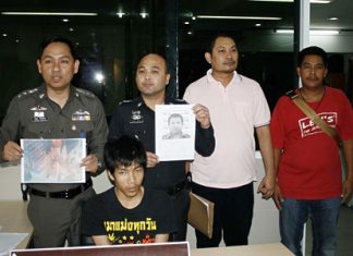 Police, shown here holding photos of two more suspects, have arrested Santhan Kammongkol (seated) for his involvement in the robbery of a 7-Eleven.